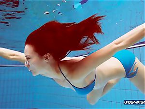 red-haired in blue bikini showcasing her body