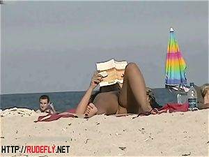 steamy honies filmed lounging on a nudist beach
